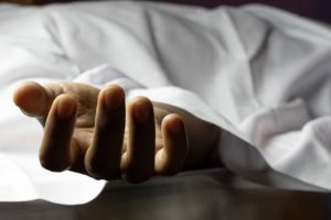 an Indian or Asian person laying dead with outstretched hand during COVID-19 or corona virus outbreak